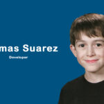 Young app developer Thomas Suarez coding on a MacBook, surrounded by devices