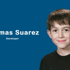 Young app developer Thomas Suarez coding on a MacBook, surrounded by devices